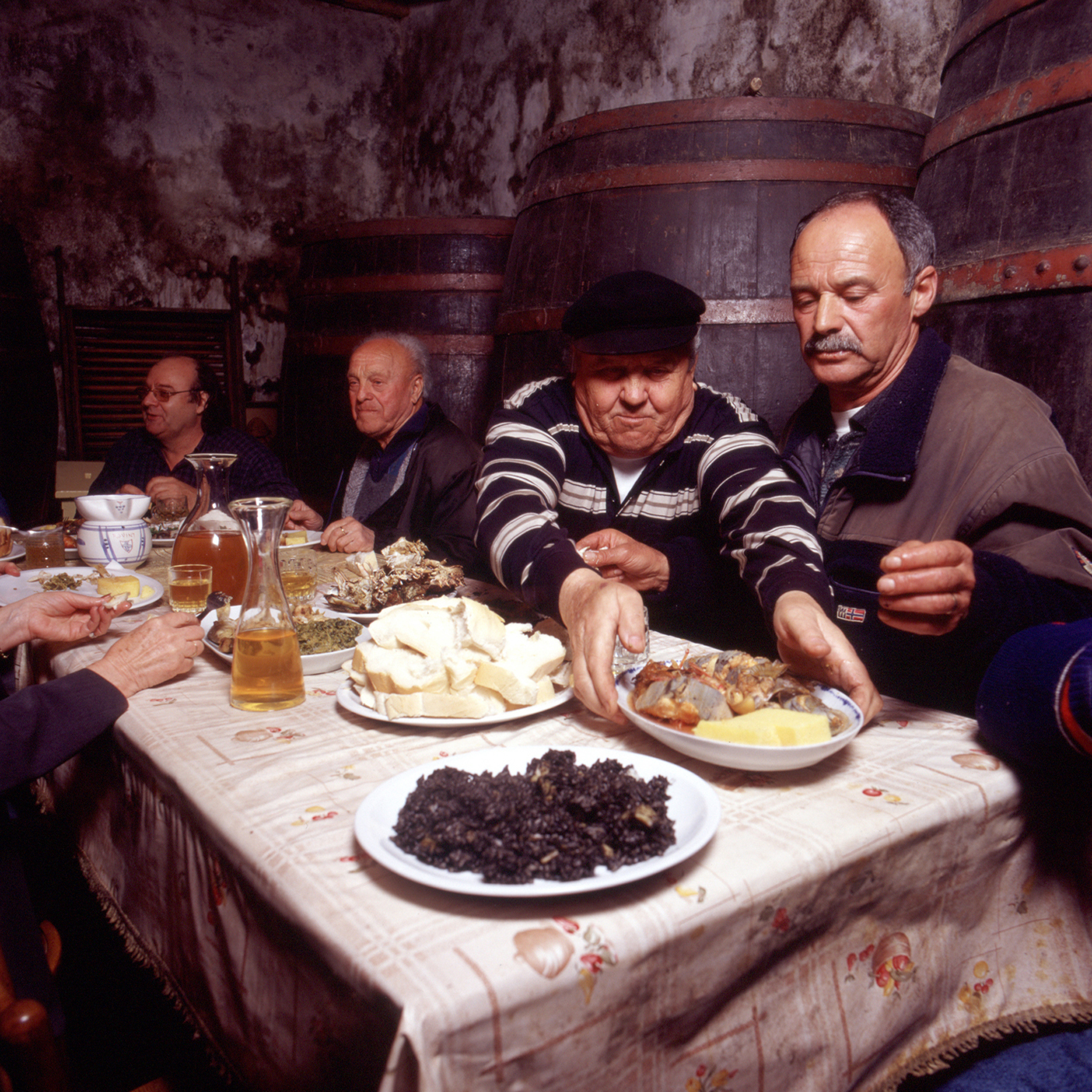 Four men enjoying a Mediterranean meal