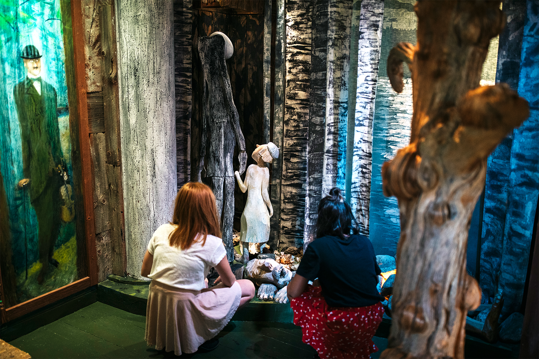 Two children in Sagobygden museum listening to storytelling